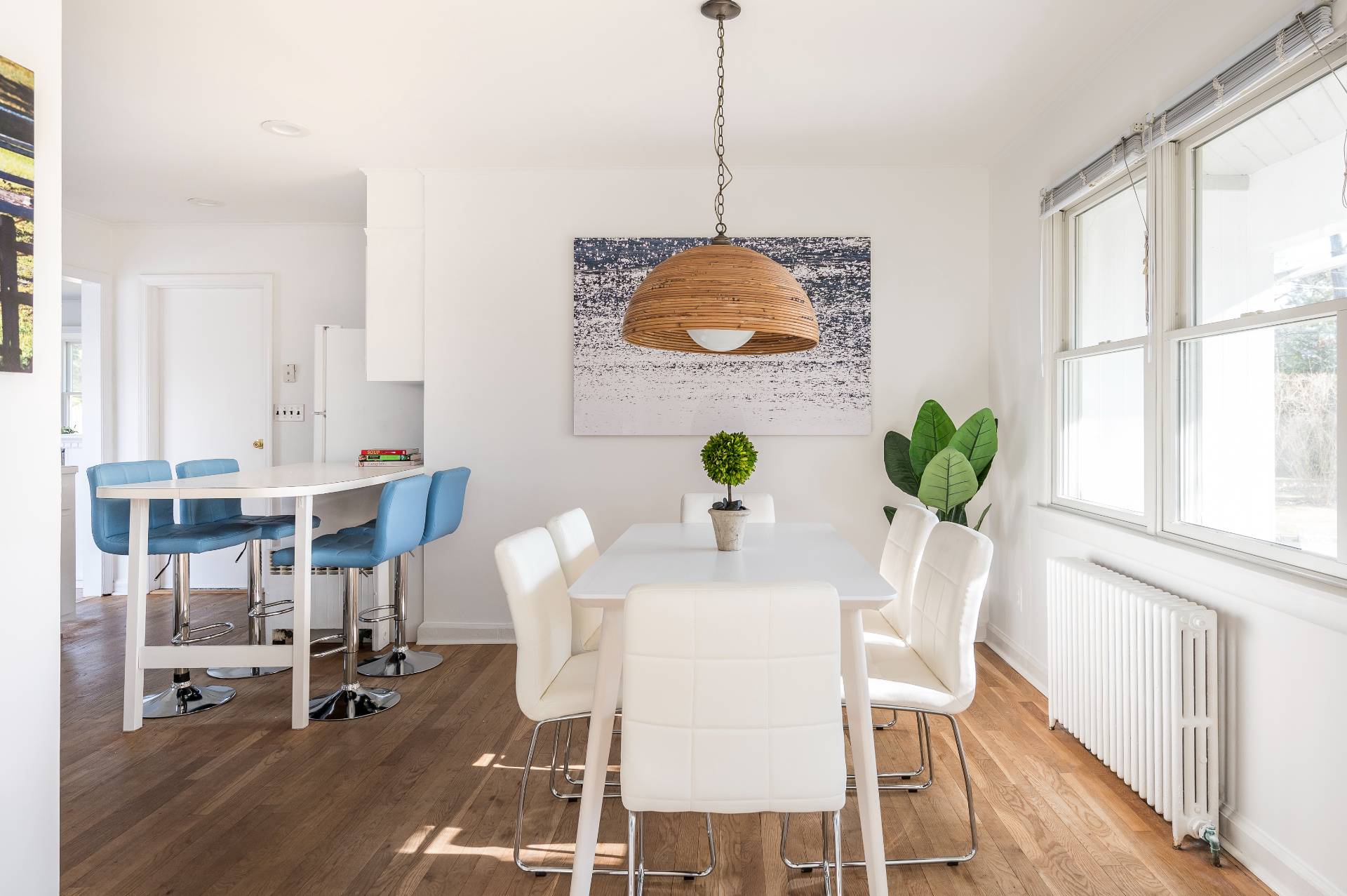 25 Lynncliff Road Hampton Bays, NY 11946 - Photo 7 of 24 a dining room with furniture a chandelier and wooden floor
