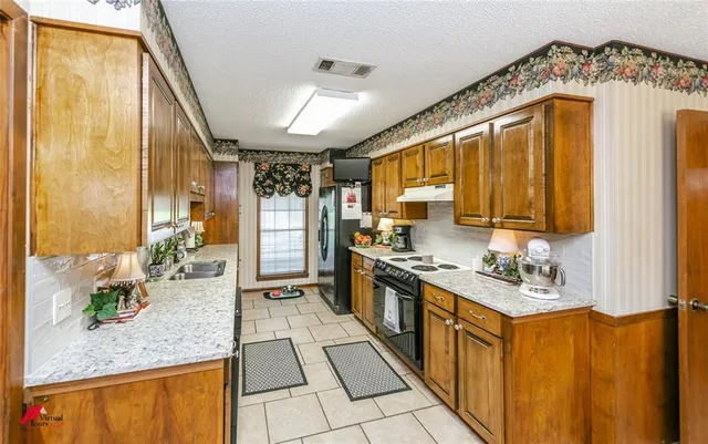a kitchen with refrigerator and cabinets
