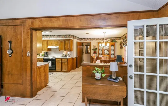 a kitchen with stainless steel appliances granite countertop a sink stove and cabinets