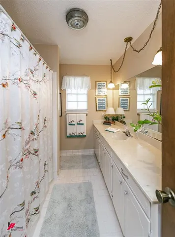 a spacious bathroom with a double vanity sink and shower