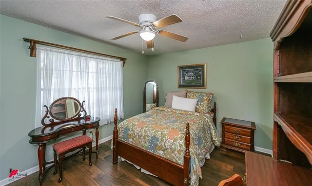 a bedroom with a bed and a dresser in it