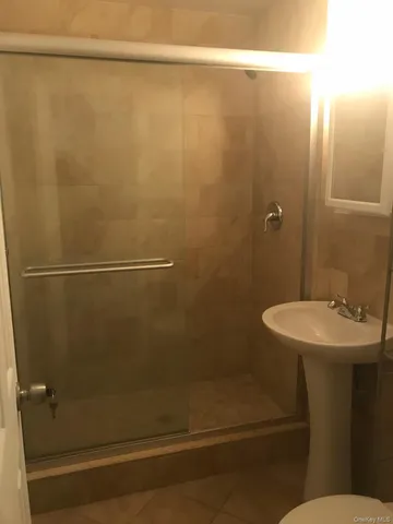a bathroom with a sink a toilet and mirror