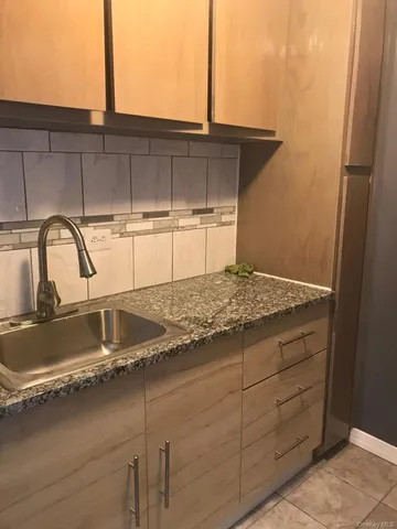 a view of a room with a refrigerator and a microwave