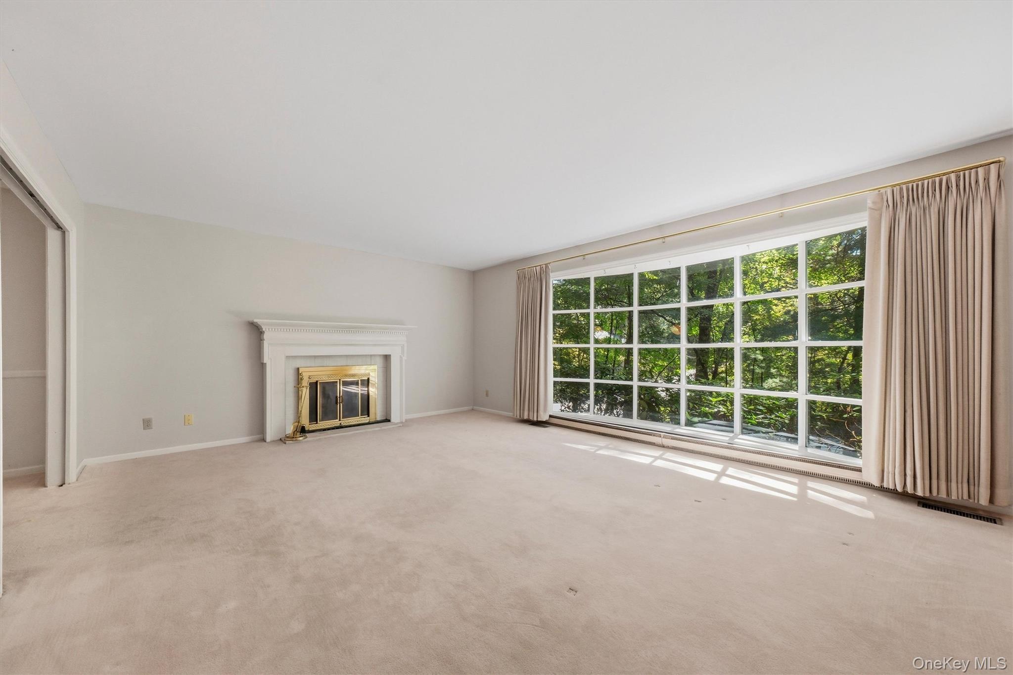 75 Pleasant Ridge Drive Poughkeepsie, NY 12603 - Photo 10 of 47 Expansive formal living room with large bow window and wood burning fireplace. Hardwood under carpet.