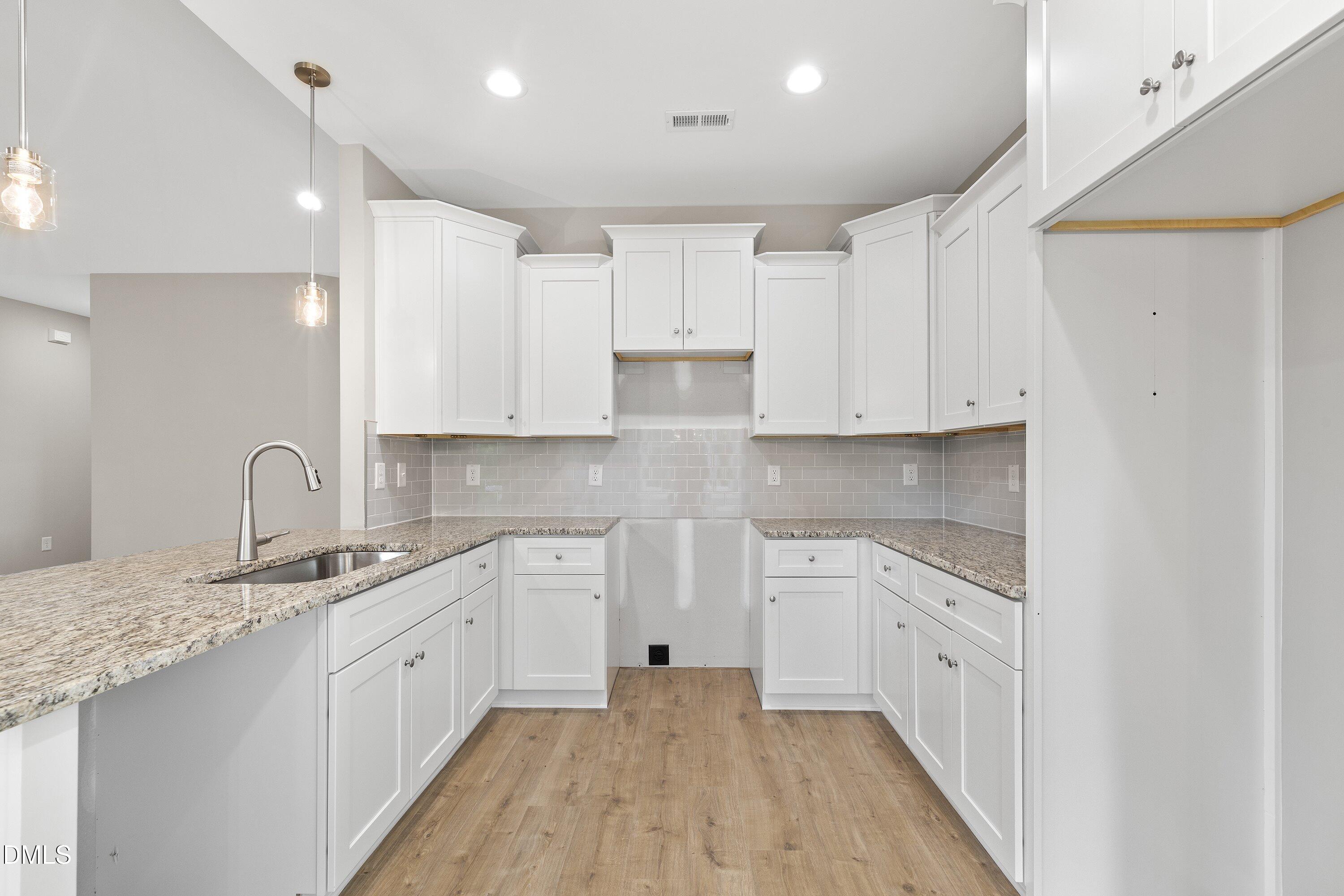 1115 Nor-Am Road Pikeville, NC 27863 - Photo 17 of 40 a large white kitchen with a white stove top oven and sink