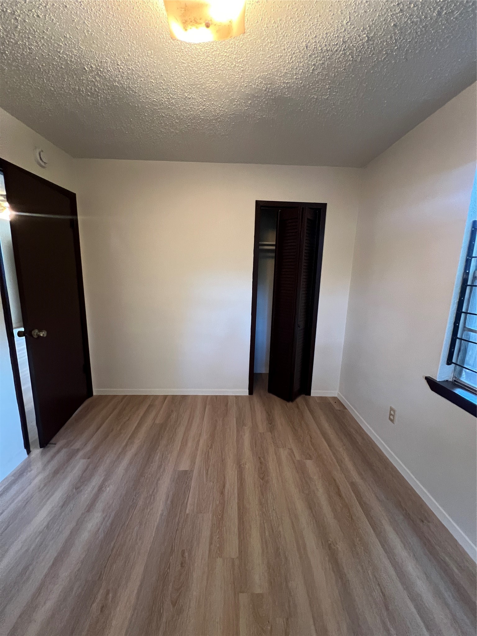 2501 Cleburne Street, Unit 1 Houston, TX 77004 - Photo 5 of 7 a view of an empty room with wooden floor and a window