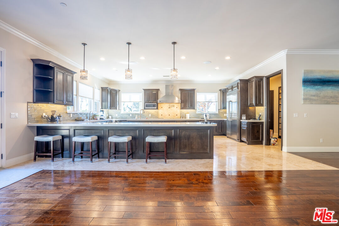 2510 Belleview Road Upland, CA 91784 - Photo 24 of 75 a dining hall with stainless steel appliances kitchen island granite countertop a dining table chairs and granite counter tops