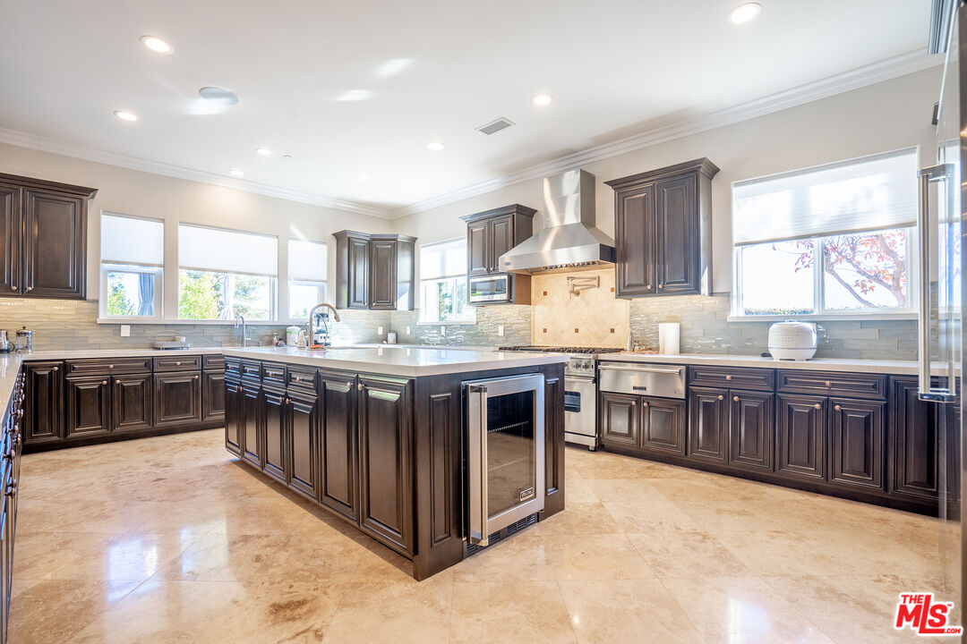 2510 Belleview Road Upland, CA 91784 - Photo 26 of 75 a kitchen with stainless steel appliances granite countertop wooden cabinets a sink a stove a window and wooden floors