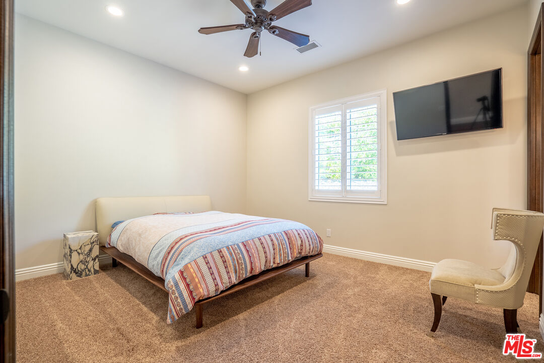 2510 Belleview Road Upland, CA 91784 - Photo 56 of 75 a bedroom with a bed window and a flat screen tv