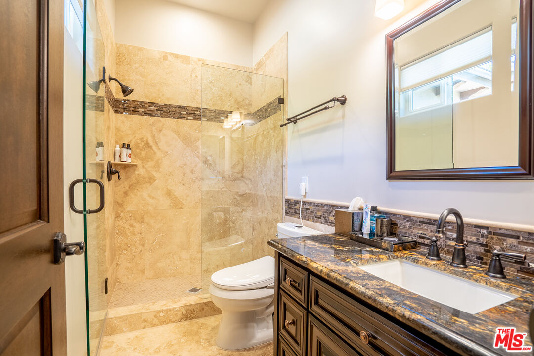 2510 Belleview Road Upland, CA 91784 - Photo 59 of 75 a bathroom with a granite countertop sink toilet and shower