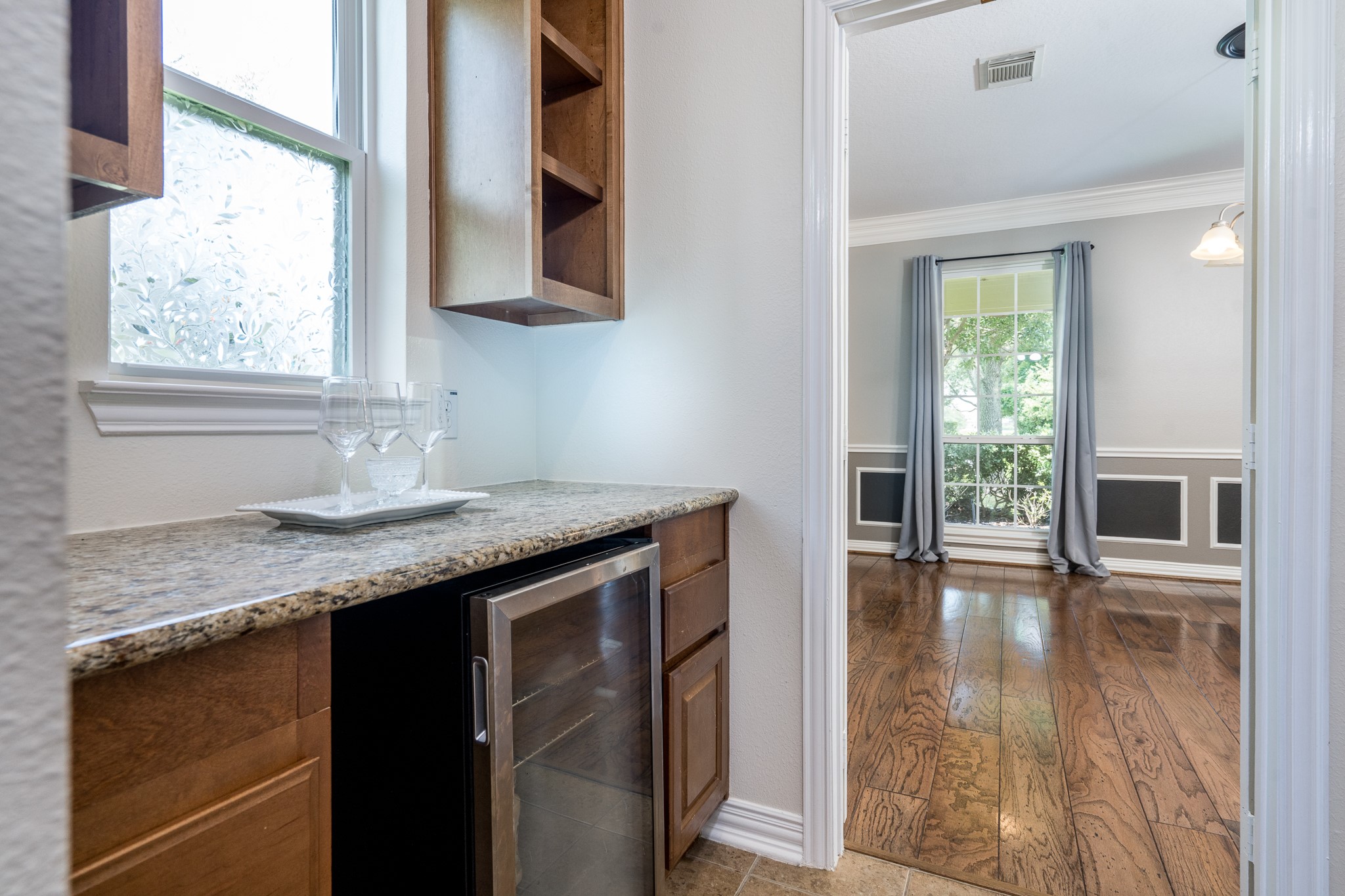 5914 Oakmoss Trail Spring, TX 77379 - Photo 14 of 50 Designed with entertaining in mind, the butler's pantry provides a seamless extension of the home’s gathering spaces. To the right is the very large walk-in pantry!