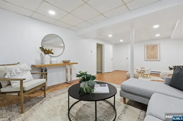 a living room with furniture and a mirror