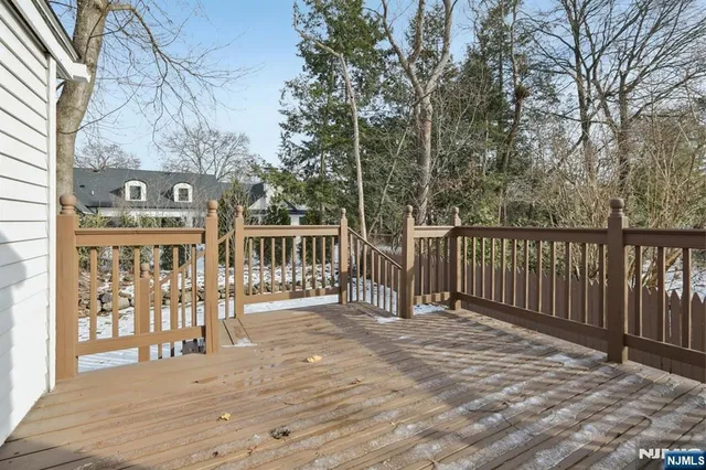 a view of a brick house with a floor to ceiling windows and a tree