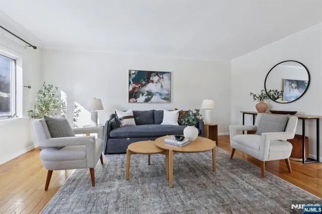 a living room with furniture a rug and a large window