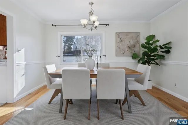a dining room with furniture potted plants and wooden floor