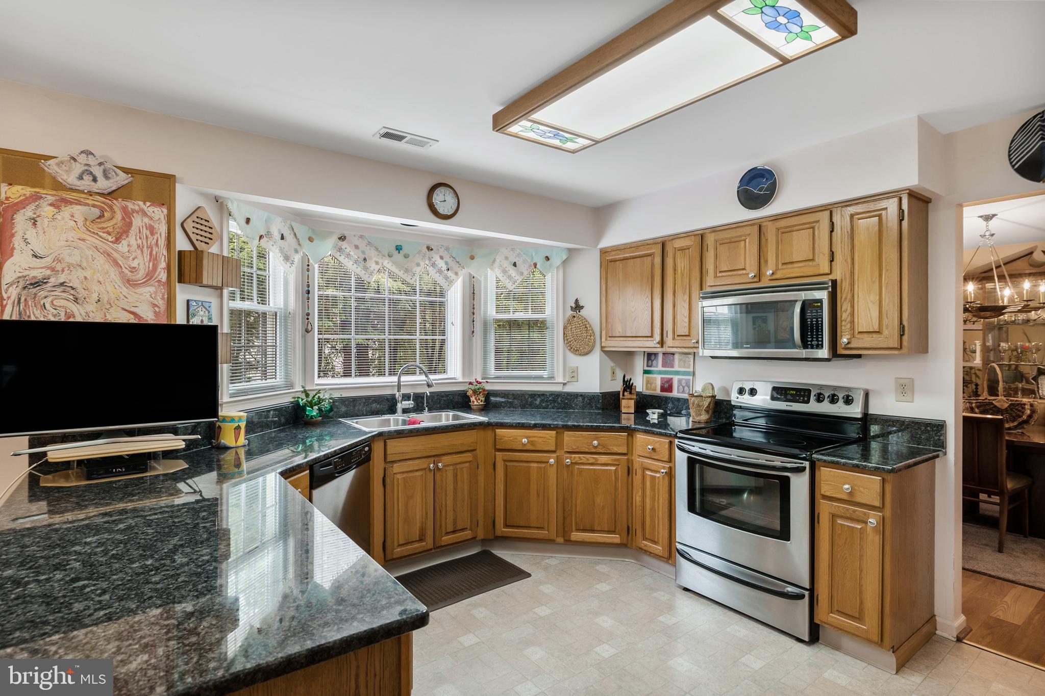10 Tansgate Boulevard Berlin, NJ 08009 - Photo 14 of 51 a kitchen with stainless steel appliances a stove sink and microwave