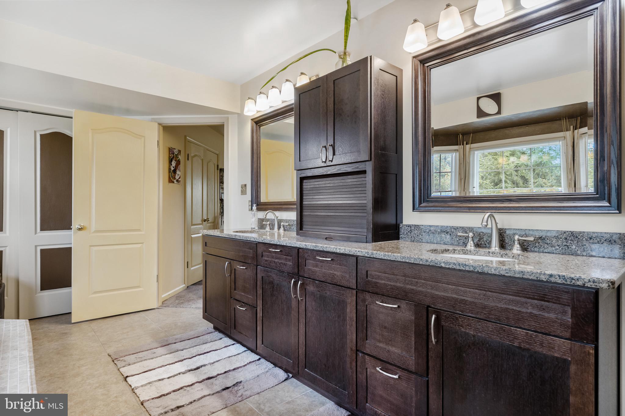 10 Tansgate Boulevard Berlin, NJ 08009 - Photo 27 of 51 a bathroom with a granite countertop sink and a mirror