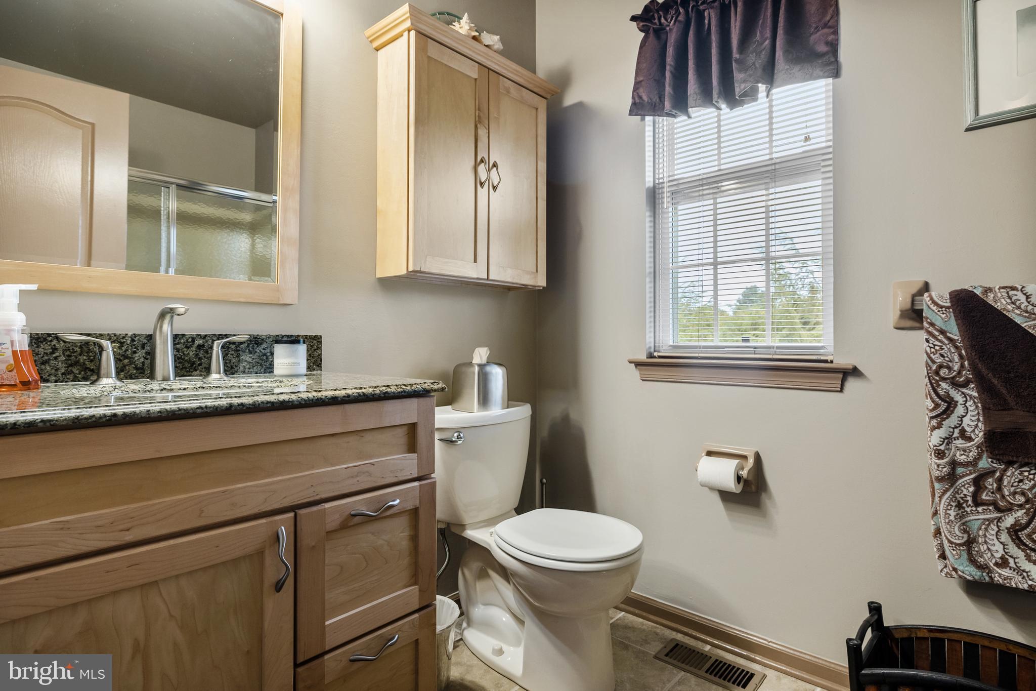 10 Tansgate Boulevard Berlin, NJ 08009 - Photo 34 of 51 a bathroom with a granite countertop toilet sink and mirror