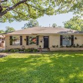 a backyard of a house with yard table and chairs