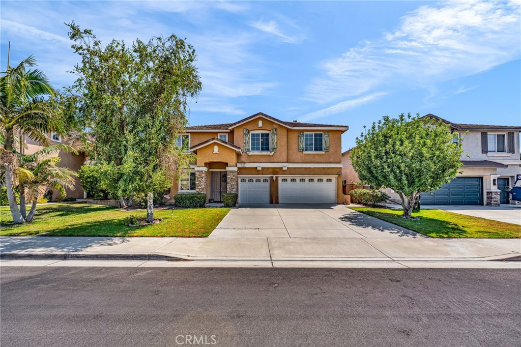 6874 Raspberry Court Eastvale, CA 92880 - Photo 1 of 36 a front view of a house with a yard and garage