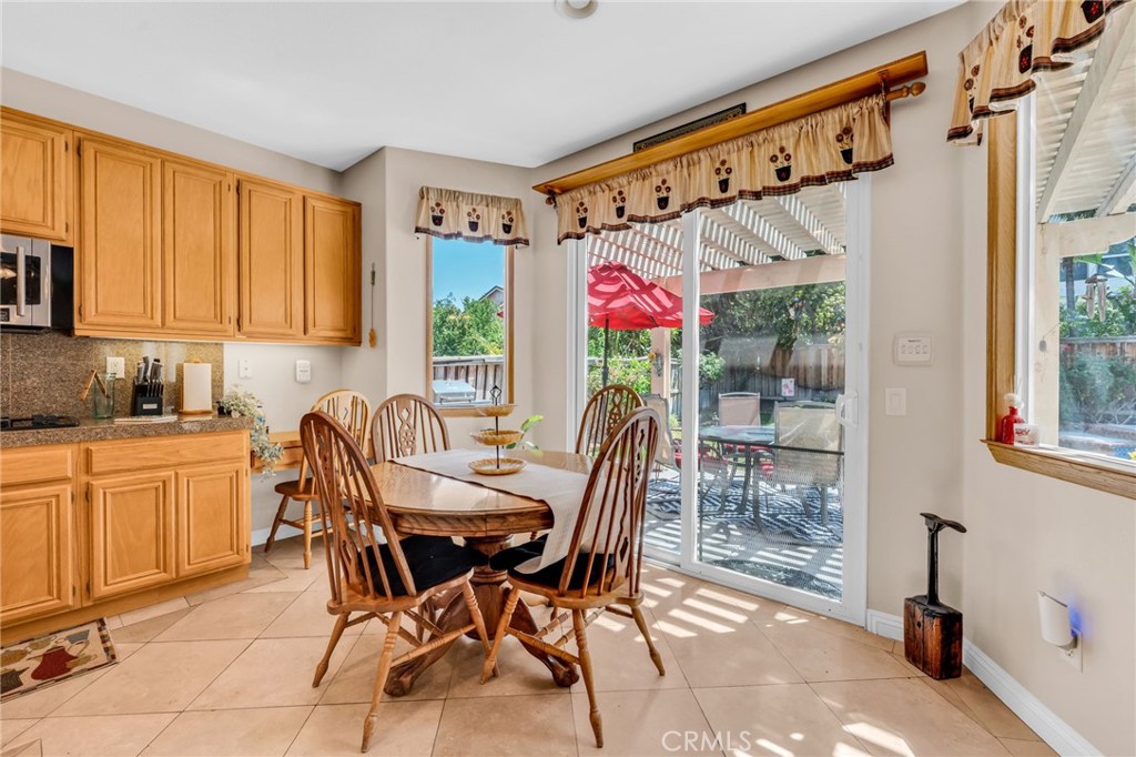 6874 Raspberry Court Eastvale, CA 92880 - Photo 11 of 36 a view of a dining room with furniture and a window