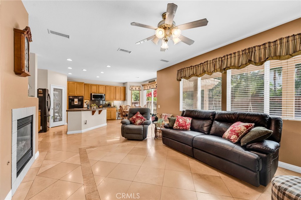 6874 Raspberry Court Eastvale, CA 92880 - Photo 14 of 36 a living room with furniture and a large window