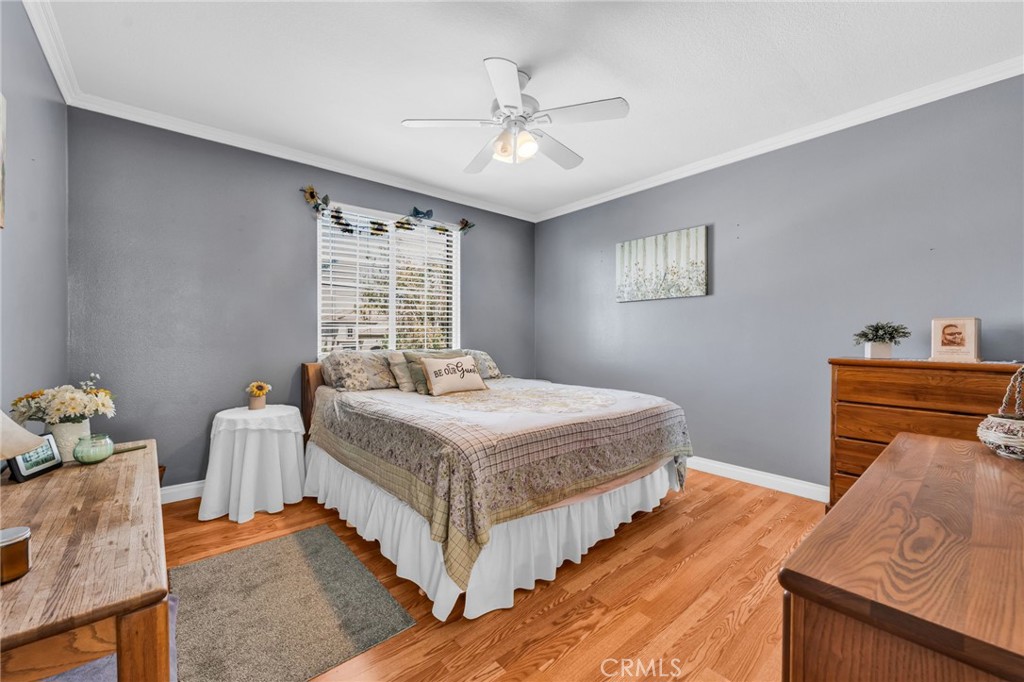 6874 Raspberry Court Eastvale, CA 92880 - Photo 15 of 36 a bedroom with a bed and window