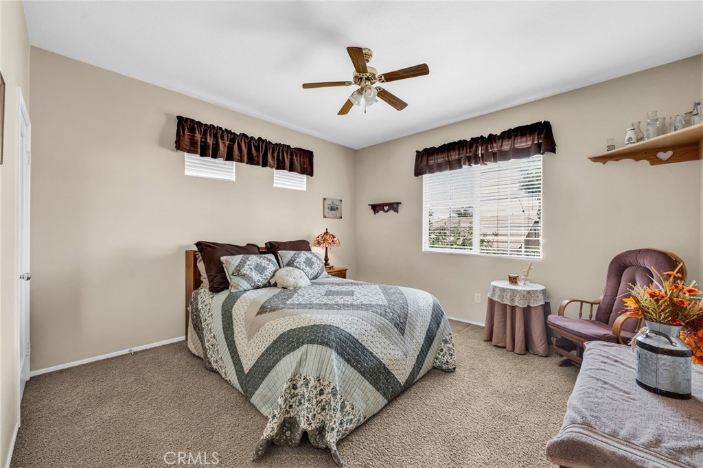 6874 Raspberry Court Eastvale, CA 92880 - Photo 16 of 36 a bedroom with bed and window