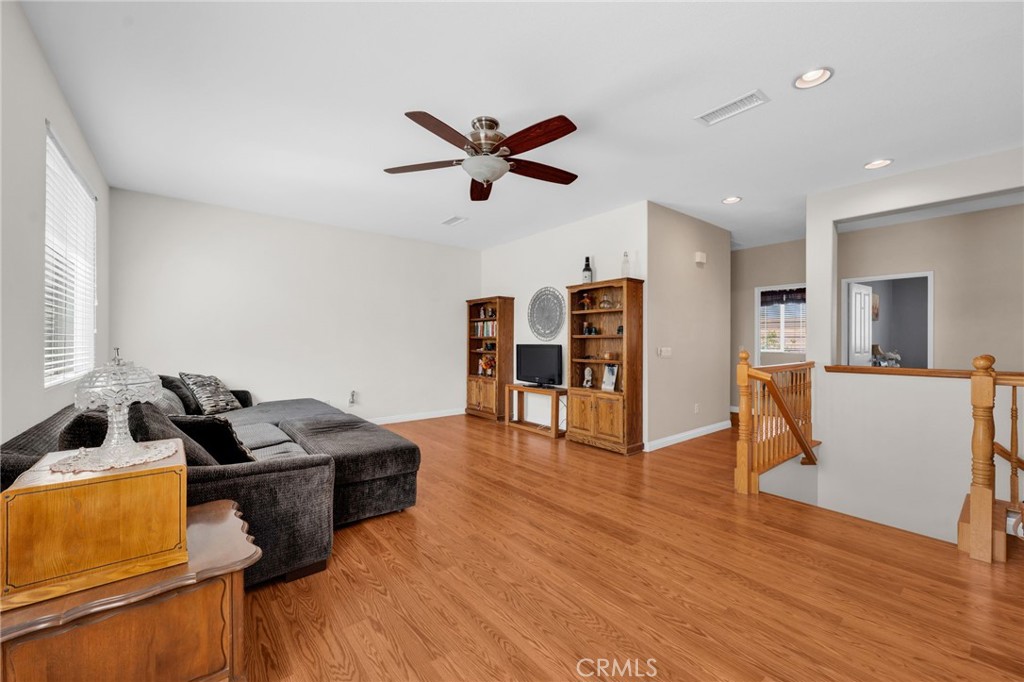 6874 Raspberry Court Eastvale, CA 92880 - Photo 20 of 36 a living room with furniture and kitchen view