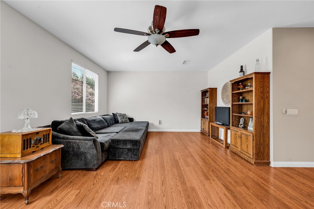 6874 Raspberry Court Eastvale, CA 92880 - Photo 21 of 36 a living room with furniture and hard wood flooring