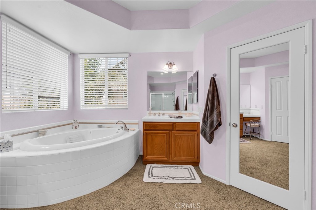 6874 Raspberry Court Eastvale, CA 92880 - Photo 25 of 36 a spacious bathroom with sink shower and bathtub