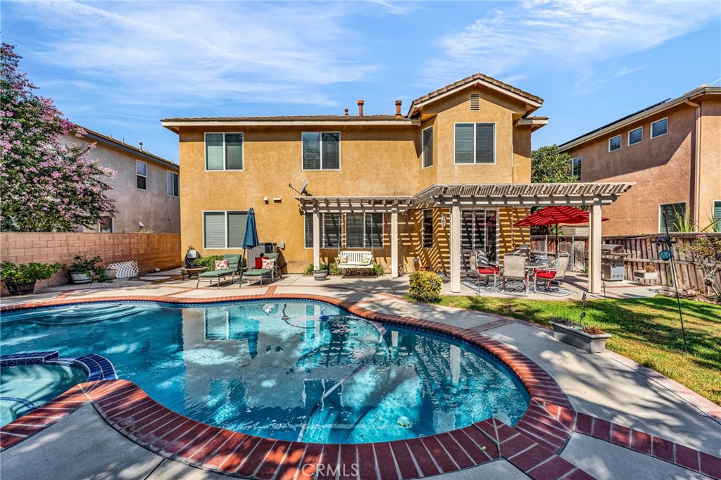 6874 Raspberry Court Eastvale, CA 92880 - Photo 3 of 36 a view of a house with swimming pool and sitting area