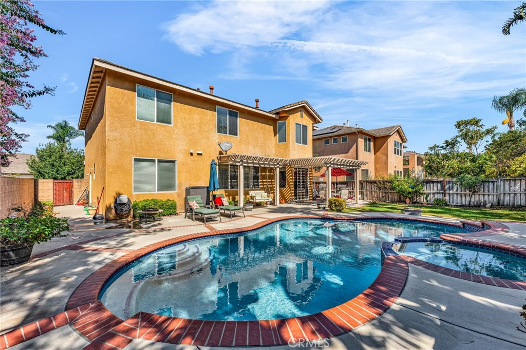 6874 Raspberry Court Eastvale, CA 92880 - Photo 32 of 36 a swimming pool with outdoor seating yard and barbeque oven