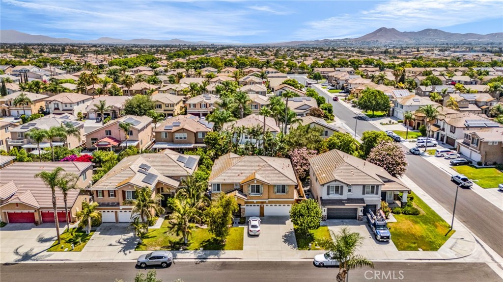 6874 Raspberry Court Eastvale, CA 92880 - Photo 35 of 36 an aerial view of residential houses with swimming pool and outdoor space