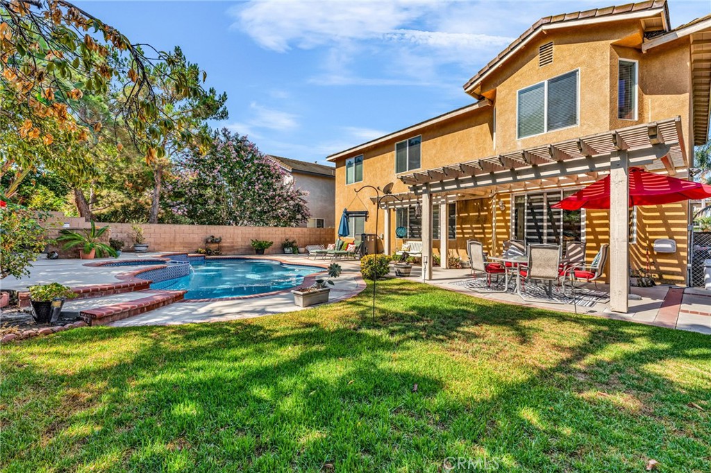 6874 Raspberry Court Eastvale, CA 92880 - Photo 4 of 36 a view of a house with backyard and sitting area