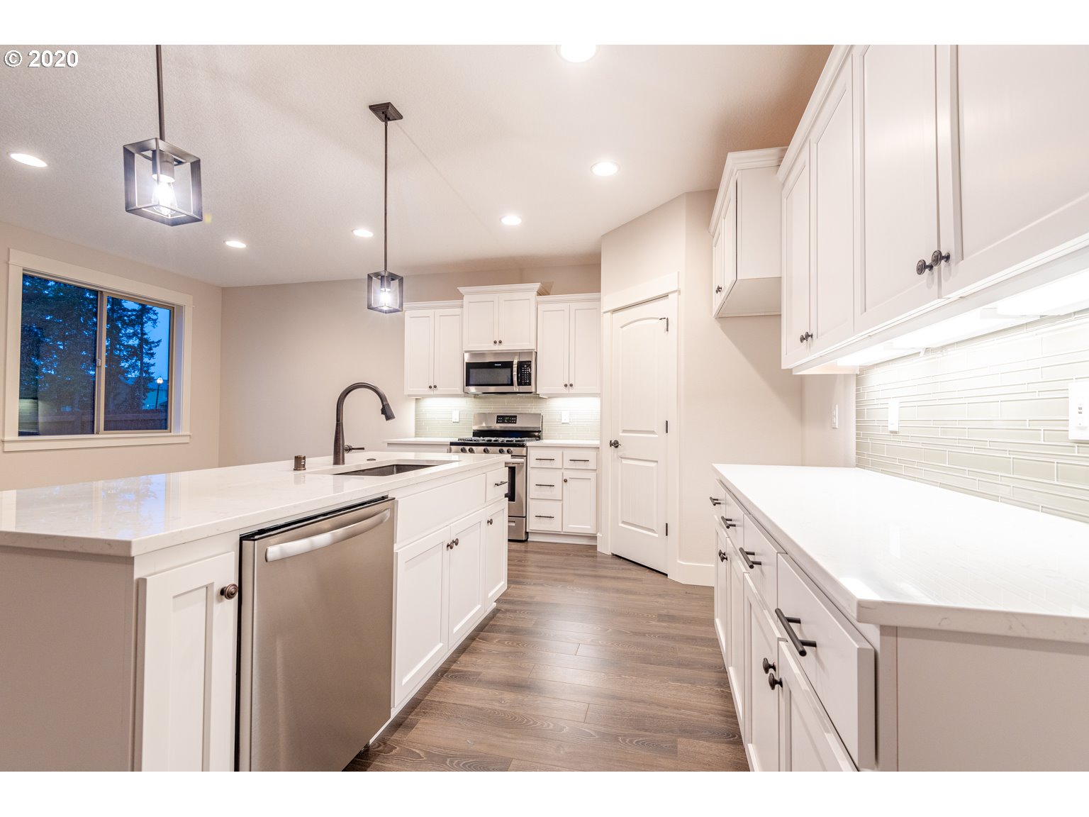 455 North 20th Place Ridgefield, WA 98642 - Photo 6 of 31 a kitchen with kitchen island a sink appliances and cabinets
