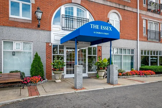 a view of a brick building with a bench in front of house