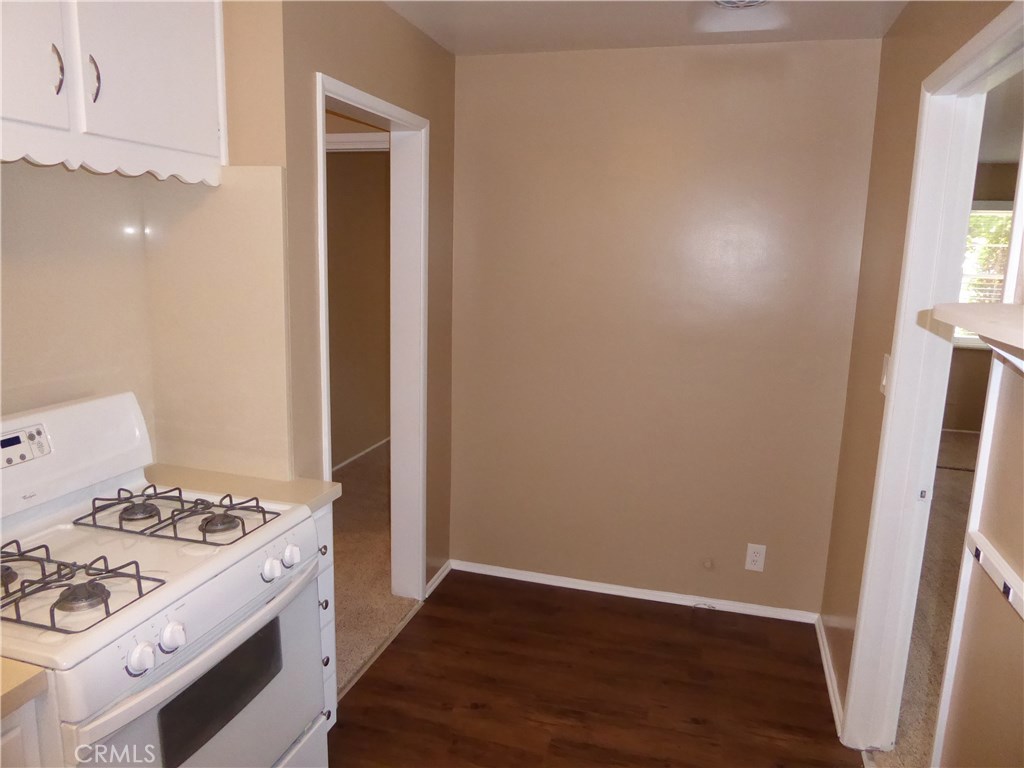 6735 Yellowstone Drive, Unit A Riverside, CA 92506 - Photo 11 of 21 a kitchen with a stove and wooden floor