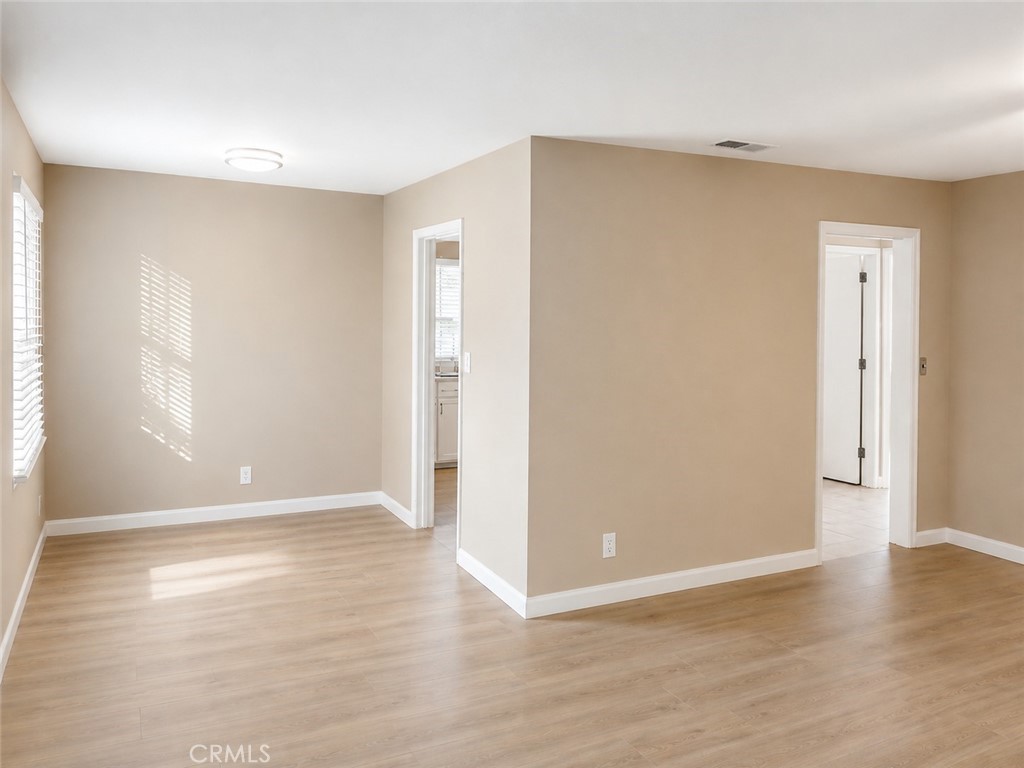 6735 Yellowstone Drive, Unit A Riverside, CA 92506 - Photo 4 of 14 a view of an empty room with wooden floor and a window