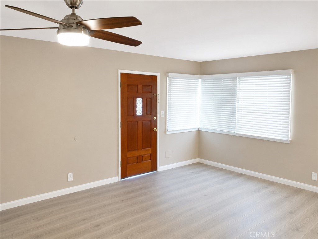 6735 Yellowstone Drive, Unit A Riverside, CA 92506 - Photo 5 of 14 a view of an empty room with a window and wooden floor