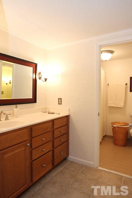 4307 Sun Belt Place Raleigh, NC 27613 - Photo 9 of 11 a bathroom with a double vanity sink and a mirror