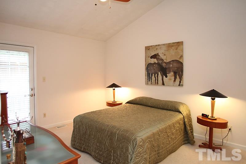 4307 Sun Belt Place Raleigh, NC 27613 - Photo 10 of 11 a bedroom with a bed and a chandelier
