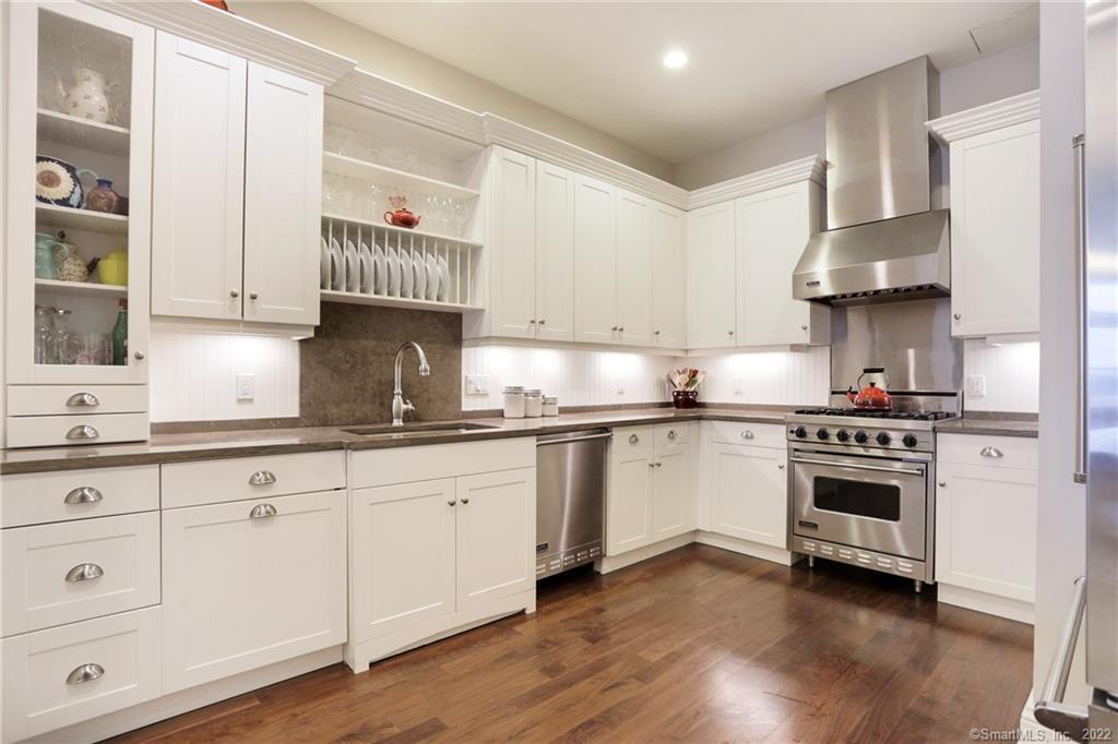 100 Stone Ridge Way, Unit 2C Fairfield, CT 06824 - Photo 1 of 1 a kitchen with granite countertop white cabinets and stainless steel appliances
