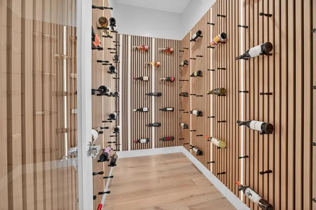 a kitchen with granite countertop a stove top oven a sink dishwasher and a refrigerator with wooden floor