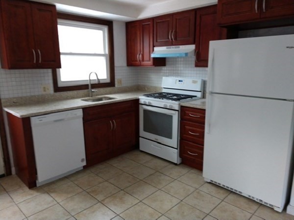 a kitchen with cabinets appliances and a sink