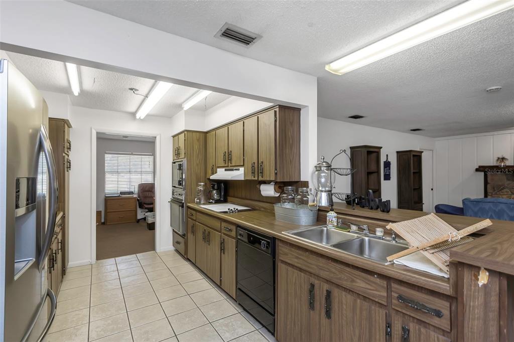 17515 Lakeshore Road Lutz, FL 33558 - Photo 16 of 61 a kitchen with stainless steel appliances a sink stove and refrigerator