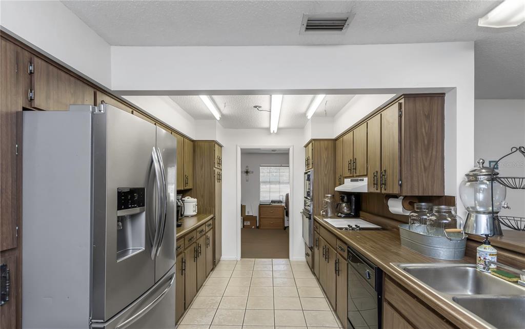 17515 Lakeshore Road Lutz, FL 33558 - Photo 19 of 61 a kitchen with stainless steel appliances granite countertop a refrigerator and a sink