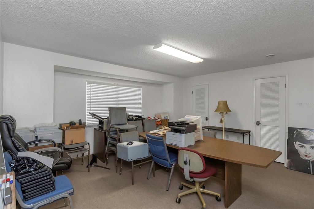 17515 Lakeshore Road Lutz, FL 33558 - Photo 23 of 61 a view of a workspace with furniture and rug in a room