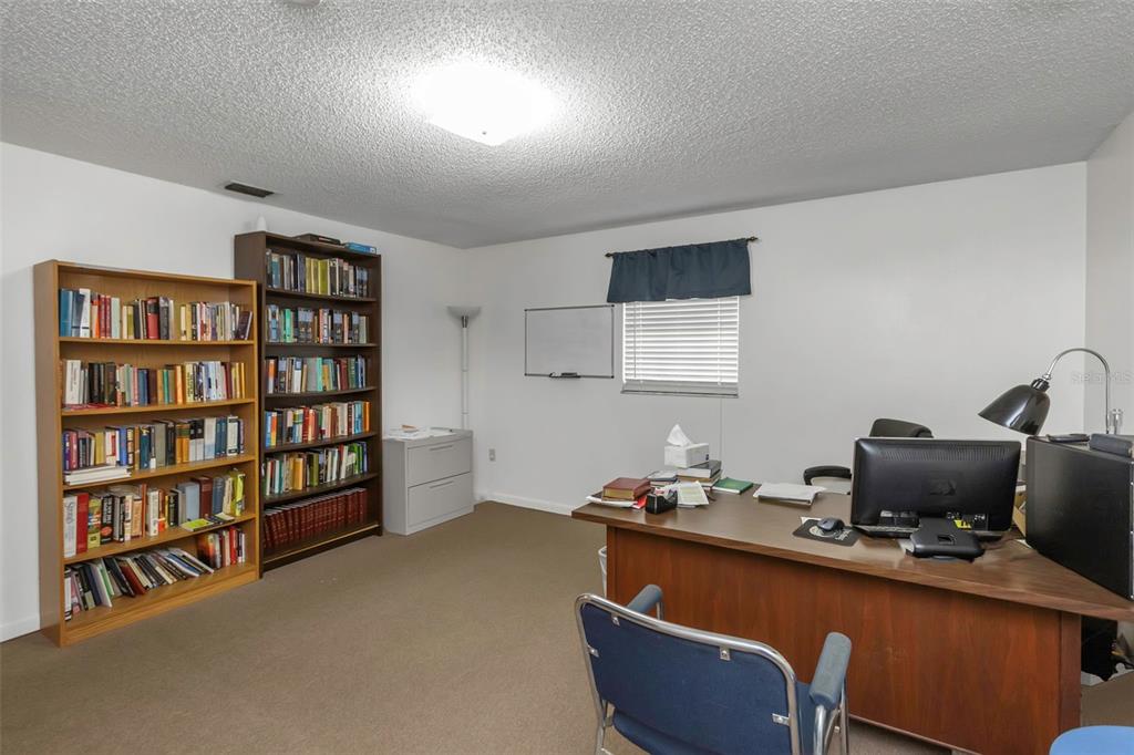17515 Lakeshore Road Lutz, FL 33558 - Photo 42 of 61 a room with furniture and a book shelf