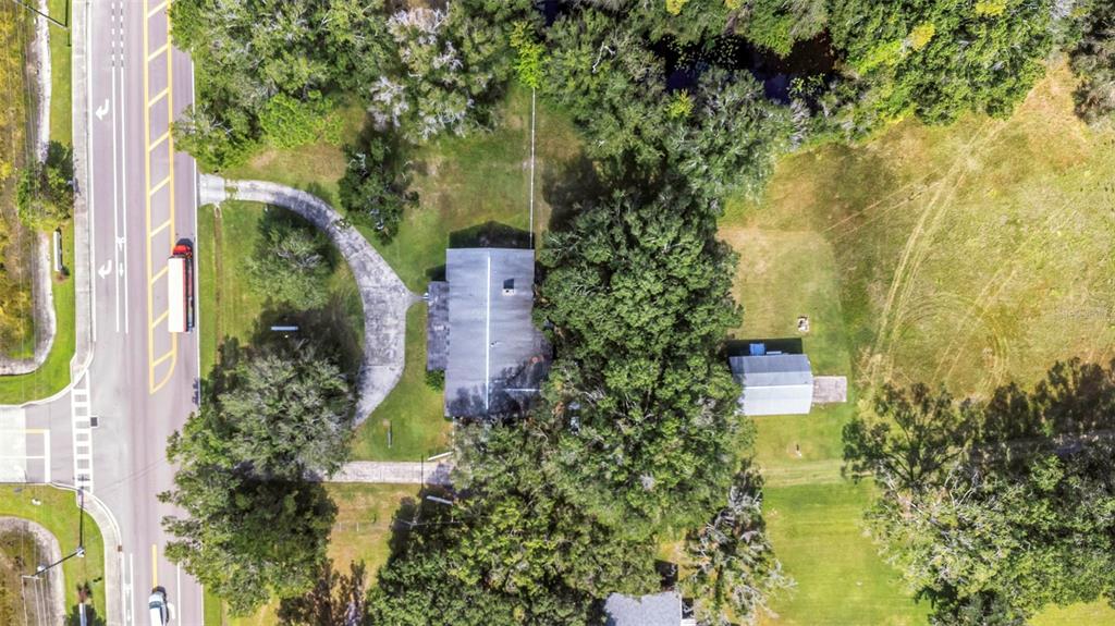 17515 Lakeshore Road Lutz, FL 33558 - Photo 56 of 61 an aerial view of residential house with outdoor space and trees all around